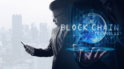 The double exposure image of the business man using a smartphone overlay with blockchain hologram image. the concept of cryptocurrency, blockchain, internet of things and future life