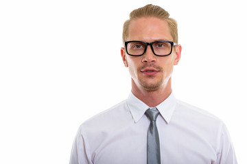 Studio shot of young handsome businessman wearing eyeglasses