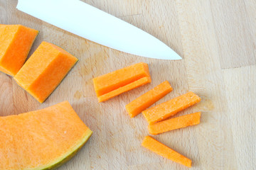 Background with pumpkin and ceramic knife, top view