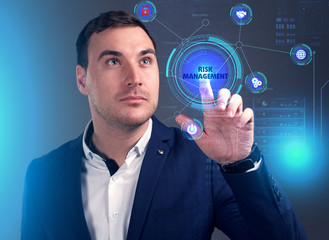 Business, Technology, Internet and network concept. Young businessman working on a virtual screen of the future and sees the inscription: Risk management