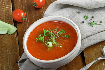 Gazpacho in a bowl, ingredients and bread. Classic Spanish cuisine vegetarian soup.