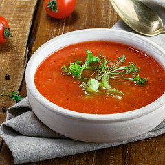 Traditional Spanish gazpacho on a rustic table. Delicious vegan cold tomato soup.