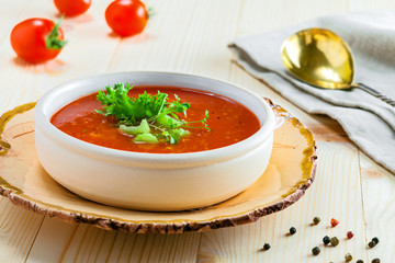 Delicious gazpacho and ingredients on a table. Vegetarian vegetable cold soup.