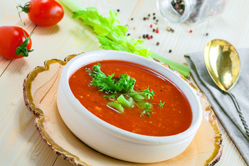 Delicious gazpacho and ingredients on a table. Vegetarian vegetable cold soup.