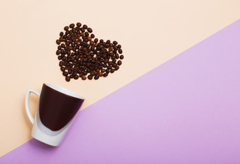 cup  with coffee beans in in the shape of a heart