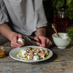 salad with  canned fish, a cucumber, egg and sauce with greens - (meal) - cuisine.  Food background