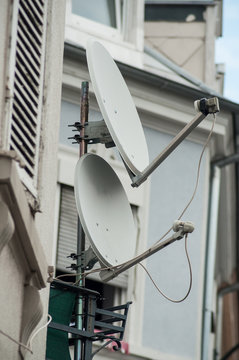 closeup of satellite antena on home facade on balcony