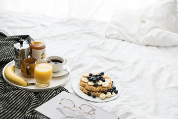Waffles breakfast in a cozy bed