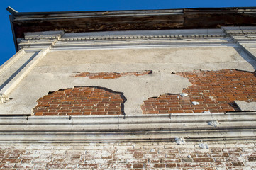 Restoration of the ancient building. Bottom view of part of the wall of the building with stucco .