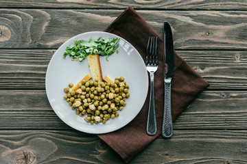 Healthy dinner on plate with cutlery on textile napkin