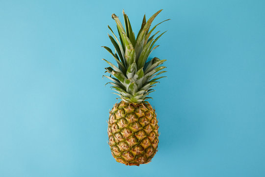 Top View Of Ripe Exotic Pineapple Fruit Isolated On Blue