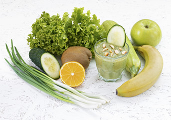 The concept of purification from detoxification, the ingredients of a green vegetable cocktail. Natural, organic healthy juice in a bottle for a diet for weight loss or fasting. 