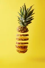 Zelfklevend Fotobehang close up view of cut ripe pineapple exotic fruit isolated on yellow © LIGHTFIELD STUDIOS