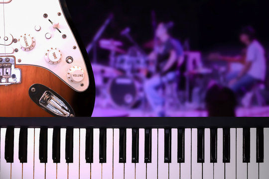 Closeup On Piano And Guitar With On Stage Concert Background In Ultra Violet Theme Lighting Background.