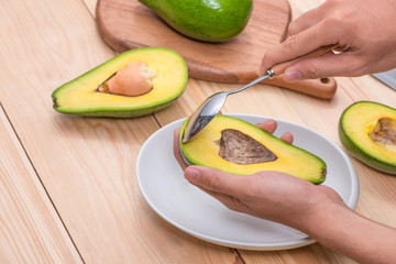 Healthy food concept. Eating fresh organic avocado