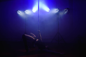 Naklejka na ściany i meble attractive sexy woman pole dancer performing