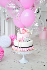 A lot of balloons pink and white colors. Decorations for birthday party. Cake for holiday party. 