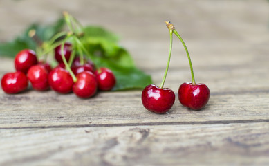 Freshly picked, delicious  cherries on old wooden table