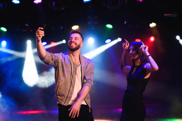 Couple take a selfie with a mobile in the night celebration