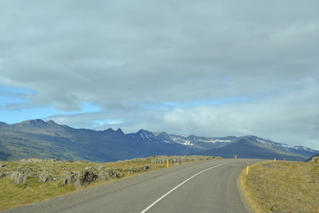 Icelandic mountain stones and road and sky
