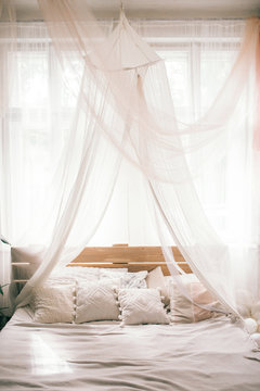 Hotel room, Wedding bed topped with pillows with canopy net. Mattress wedding.