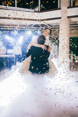 First wedding dance of newlywed. Amazing dancing bride and groom on low light and heavy smoke.  A lot of confetti.