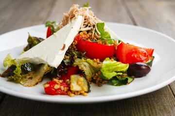 Healthy vegetable salad with feta and cashew, close up. Mediterranean cuisine, dining, diet food concept