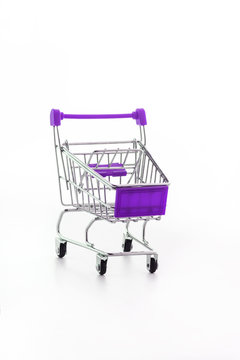Close up of supermarket grocery push cart for shopping with black wheels and plastic elements on handle isolated on white background. Concept of shopping. Copy space for advertisement.