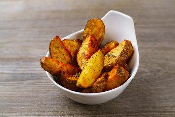 Baked potatoes with herbs and spices, delicious home cuisine, family restaurant, countryside dinner,  menu, cooking concept 