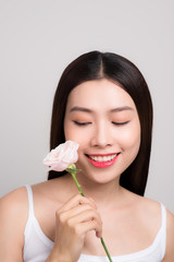 Beauty woman looking at camera with a rose flower
