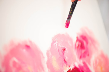Artist close-up painting flowers.