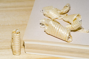 Wooden shavings of a stack of paper sheets. The concept of recycling of natural resources.