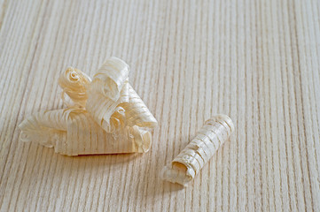 Wood shavings lying on a wooden Board. Background. Do-it-yourself concept.