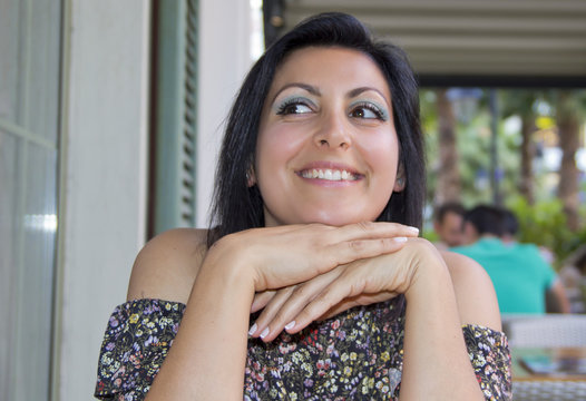 Happy and beautiful woman portrait in cafe