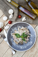 A vegetarian pasta with mushrooms and cherry tomatoes, parmesan and basil