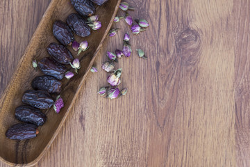 date on the wooden background with rose . ramadan concept.