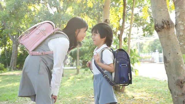 Cute Asian children going to the school outdoors slow motion 