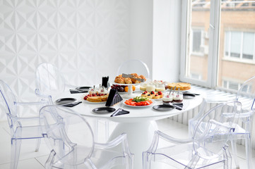 Beautiful european buffet. A lot of food for breakfast. White table. 