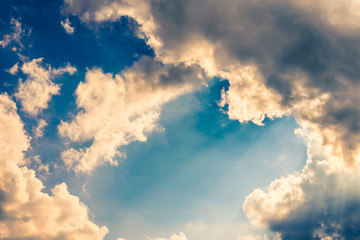 Sun rays and blue sky with dramatic clouds