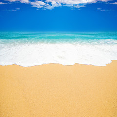 Fototapeta na wymiar Beautiful beach Background with Soft wave of blue ocean, white sand and blue sky with clouds. Summer travel holiday concept.