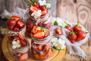 Fresh strawberries in jars