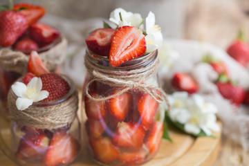 Fresh strawberries in jars