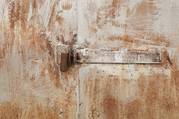 Old rusty padlock on the metal door
