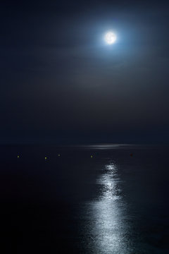 Full moon of August over a calm sea. Portrait orientation Fine Art