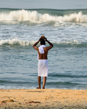 Traditional Morning Puja  In The Holy Place On Varkali Beaches In The Kerala State In India. Pilgrims Walk Down To The Sea To Offer Puja