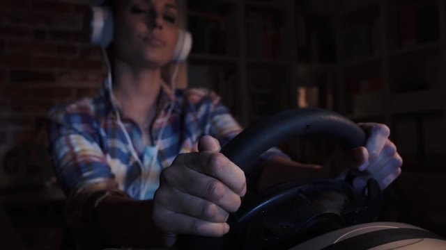 Woman playing video games with a racing controller