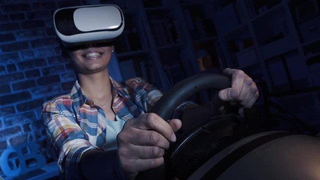 Woman playing with a driving simulator video game