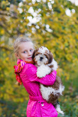 Cute girl hugging a puppy Shih Tzu