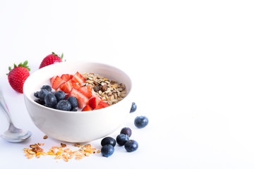 Smoothie bowl with yogurt, fresh berries and cereal. Isolated on white background