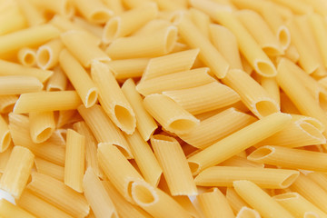 heap of raw pasta. top view. background. close up. italian food or cuisine